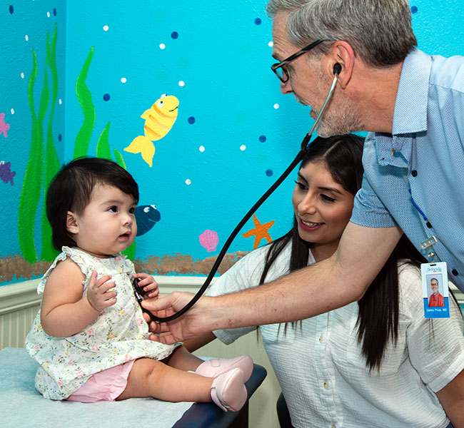 Bethesda Pediatrics - A doctor checking a baby girl heartbeat